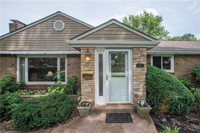 The inviting front entry is flanked by greenery, p