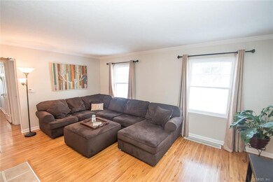 Large Living Room With Hardwood Flooring, Crown Mo