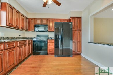 The kitchen has been updated with custom cabinets,