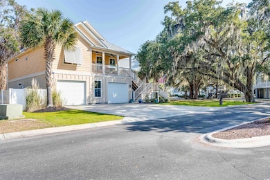 View of front of house featuring a garage and a ba