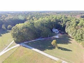 Birds eye view of property with a view of trees