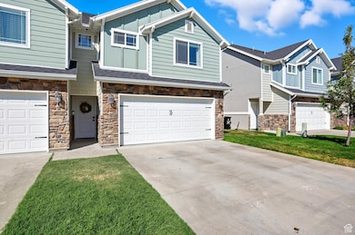 Craftsman-style house with concrete driveway, a garage, board and batten siding, stone siding, and a front yard