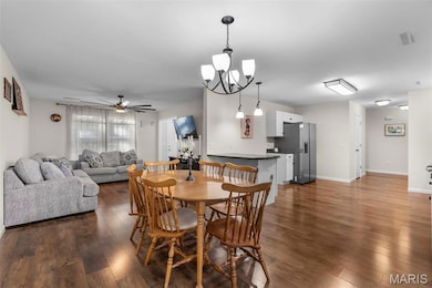 The dining room brings everyone together — linking the living room, kitchen, and privacy-fenced patio.