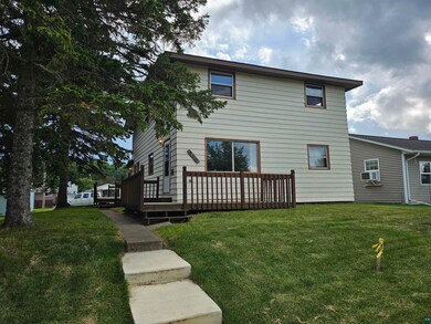 Rear view of house featuring cooling unit, a woode