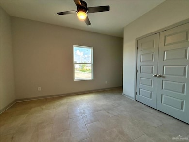 Unfurnished room featuring baseboards and ceiling fan