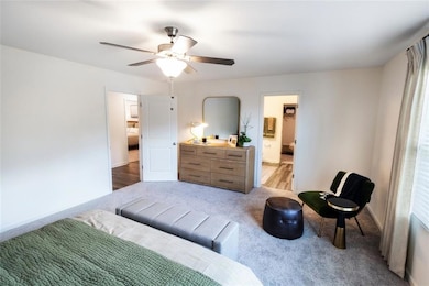 Bedroom with ceiling fan and hardwood / wood-style floors