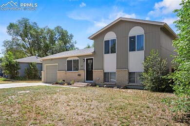 Tri-level home with a garage and a front yard