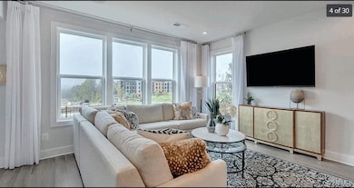 Living area featuring baseboards and light wood-ty