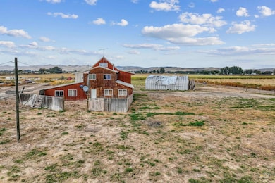 View of yard with a barn, an outbuilding, and a view of rural / pastoral area