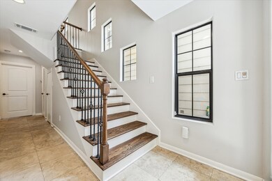 First floor entrance features natural light and a