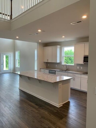 Large granite island and white farmhouse cabinets!
