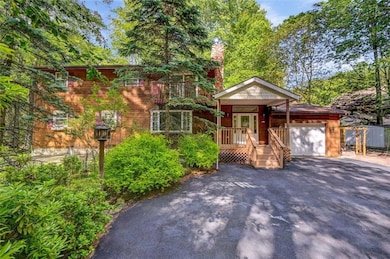 Low maintenance cedar siding and a paved driveway.