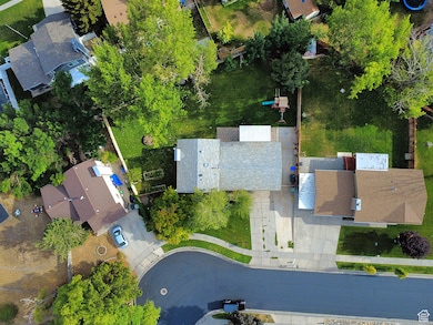 Aerial view of property and surrounding area featuring nearby suburban area
