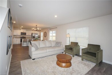 Living room open to dining space and kitchen