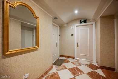 Hall featuring lofted ceiling and baseboards