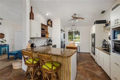 Kitchen with white cabinets, a kitchen breakfast b