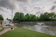 View of community featuring a water view, a lawn, and a gazebo