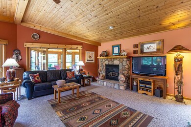 Living room with wooden ceiling, a fireplace, carp