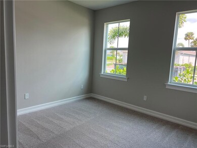 Empty room featuring carpet flooring and baseboard