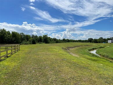The stake shows the main property line on the southern side. You can put in whatever kind of driveway or road you want, and you will maintain everything in the easement.