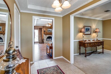 Hall with light tile patterned flooring, and a cha