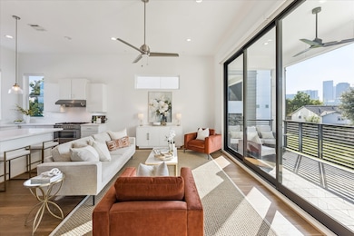 The main living level impresses with soaring 12-foot ceilings and a stunning 10-foot retractable sliding door that opens to a spacious 8x15-foot patio. Flooded with natural light, the room feels bright, airy, and expansive.