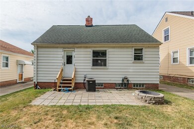 Back of house featuring a patio, an outdoor fire pit, and a yard