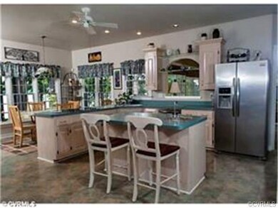 Kitchen with bar seating and large eat-in area ove