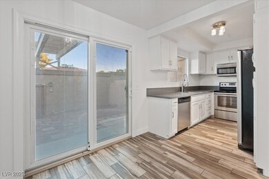 Kitchen with white cabinets, healthy amount of natural light, and appliances with stainless steel finishes