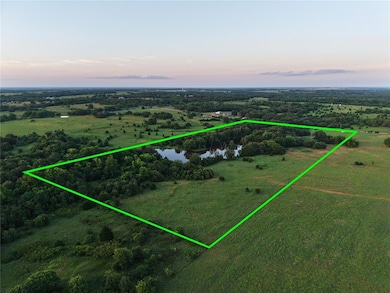 Overview of rural landscape featuring property boundaries highlighted and a large body of water