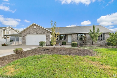 Ranch-style house with driveway, brick siding, an attached garage, and a shingled roof
