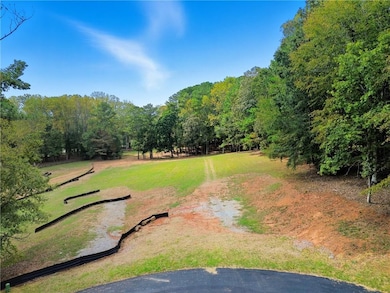View of property's community with a lawn