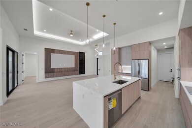 Kitchen with modern cabinets, appliances with stai