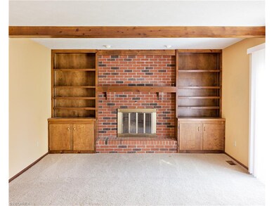 The comfortable family room with a toasty brick fi