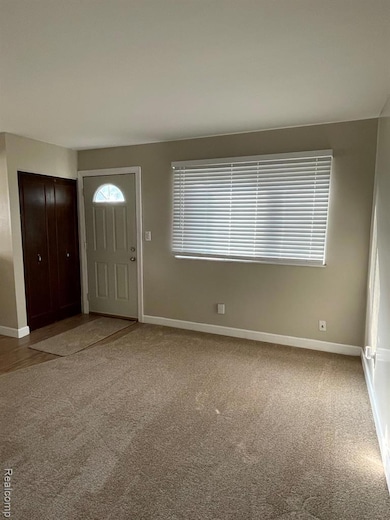 Foyer entrance with light carpet