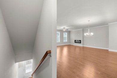 Unfurnished living room featuring ceiling fan with