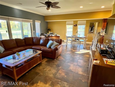 Living area featuring crown molding, recessed lighting, and ceiling fan