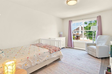 Bedroom with wood finished floors and baseboards