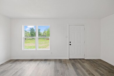 Unfurnished room with wood finished floors and ba