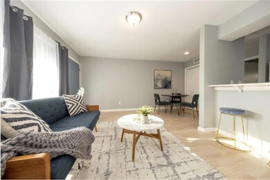 Living room with baseboards, wood finished floors