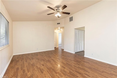 Unfurnished room with dark hardwood / wood-style f