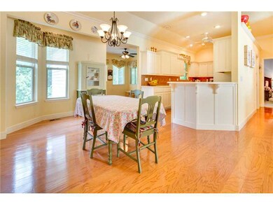 Kitchen. Large dining space is open to the kitchen and living areas.  The wood floors continue here.