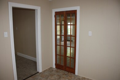 From kitchen to living room on left and french doors to den/dining area.