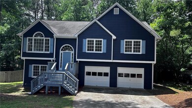 Split foyer home with driveway, an attached garage