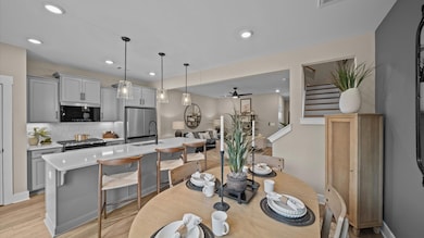 Kitchen with gray cabinetry and large island for counterstools