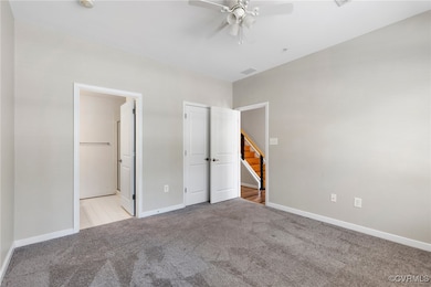 Unfurnished bedroom with carpet, visible vents, a