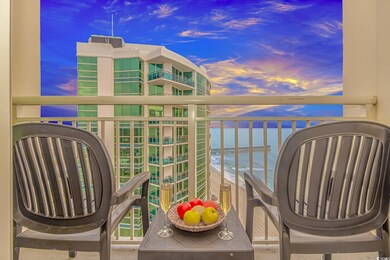 Balcony at dusk featuring a water view