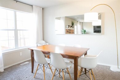 Carpeted dining space with visible vents, baseboards, and a healthy amount of sunlight