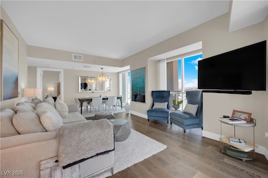 Living room with an inviting chandelier, visible v