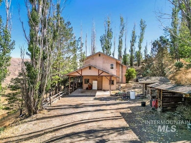 View of front of house featuring driveway, a chimney, and an attached carport